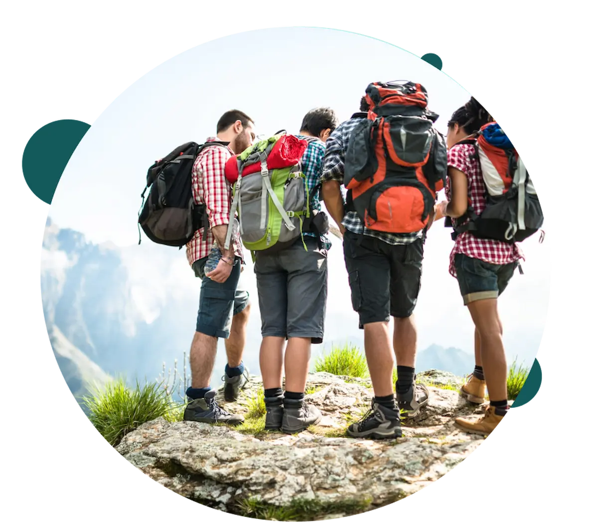 Hikers with backpacks standing on a mountain rock